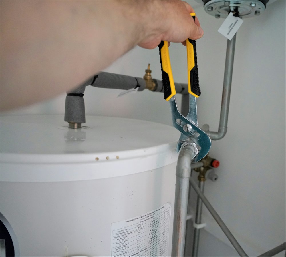 Plumber working on a water heater connection